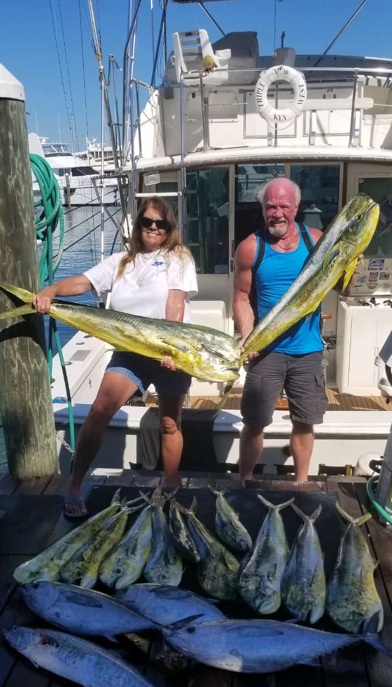 Man and woman with the large amount of fish caught on Triple Time.