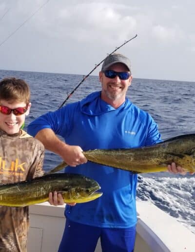 Father and son caught a dolphin fish.