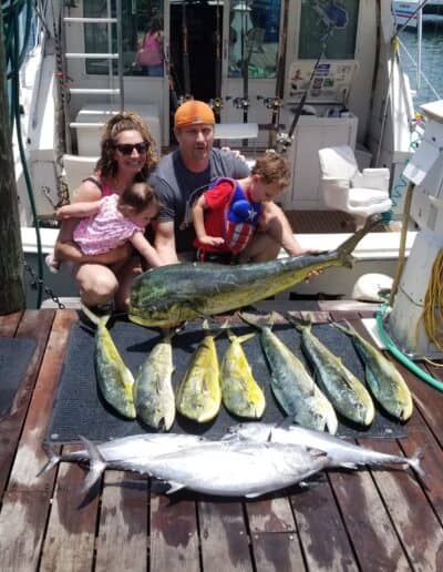 Family of four and the fish they caught on Triple Time.